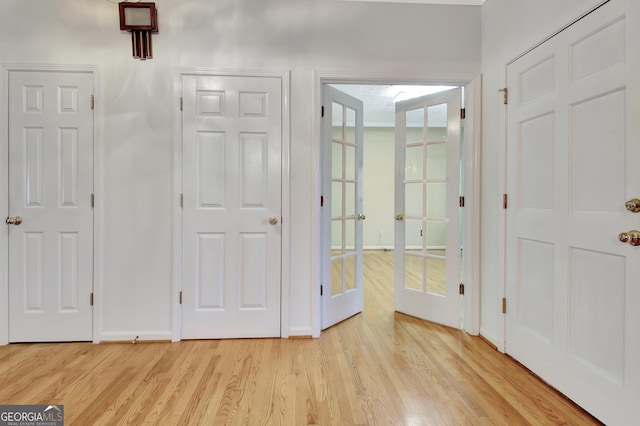 interior space with french doors and light wood-type flooring