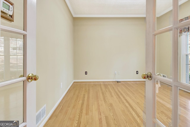 spare room with crown molding and hardwood / wood-style floors