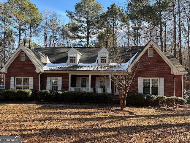 cape cod-style house with a porch