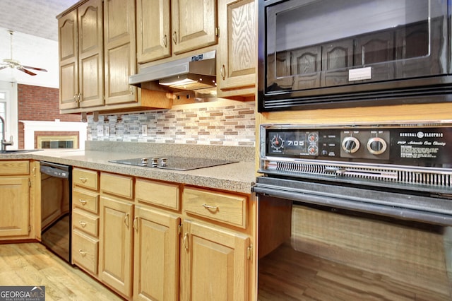 kitchen featuring black appliances, tasteful backsplash, sink, ceiling fan, and light hardwood / wood-style flooring