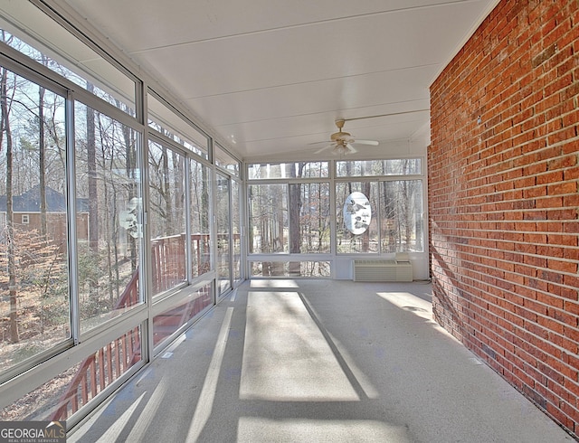 unfurnished sunroom featuring ceiling fan