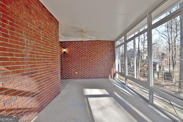 unfurnished sunroom featuring ceiling fan