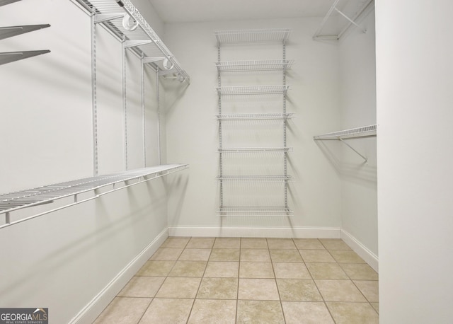 spacious closet featuring light tile patterned floors