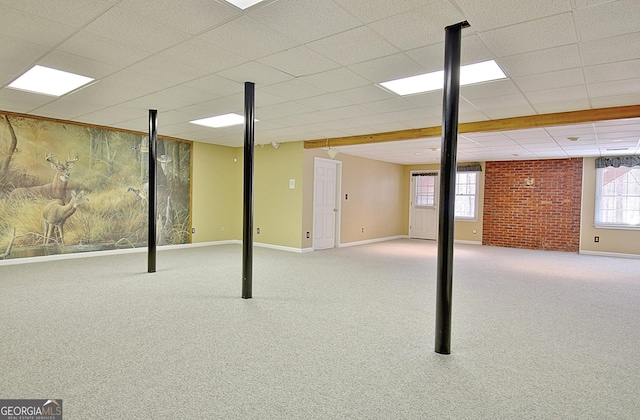 basement with light colored carpet and brick wall