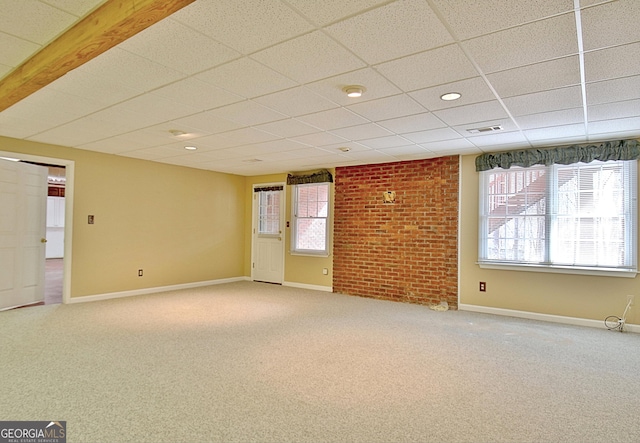 spare room with carpet and a drop ceiling