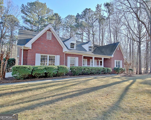 view of front facade with a front lawn and covered porch