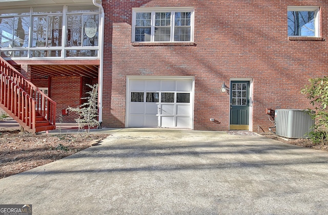 property entrance featuring central AC and a garage