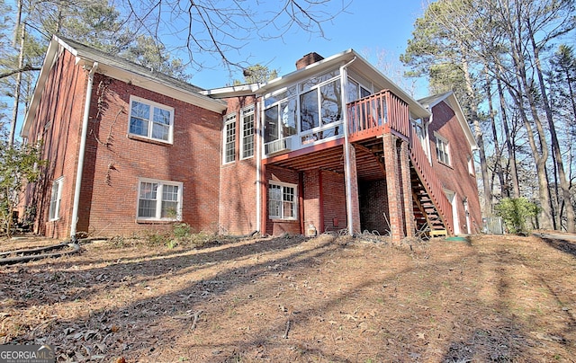 back of house featuring a deck and a sunroom