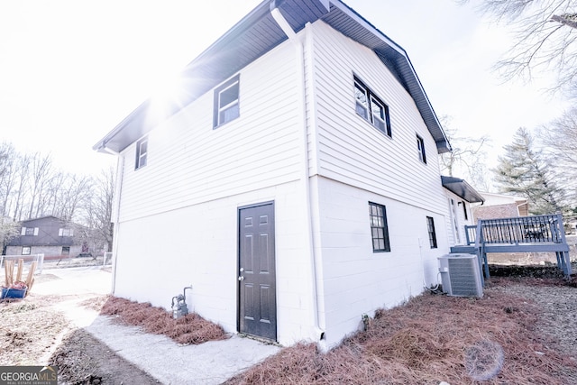 view of home's exterior featuring a deck and cooling unit