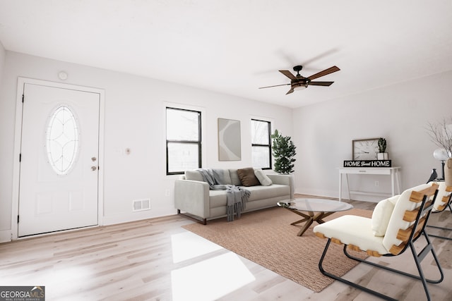 living room with ceiling fan and light hardwood / wood-style floors