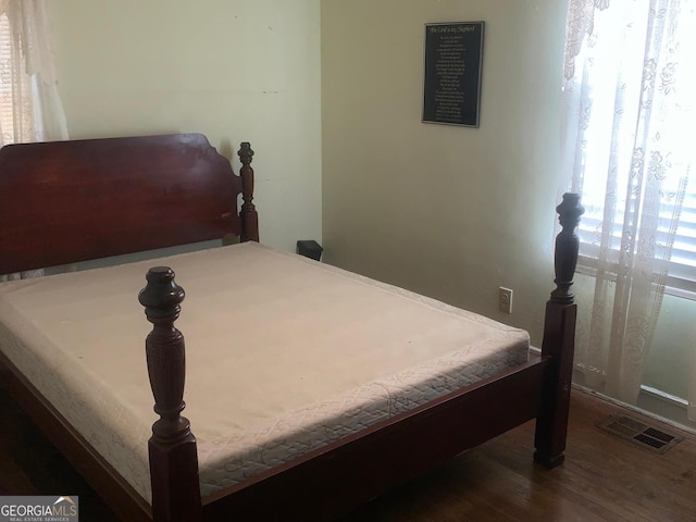 bedroom featuring dark wood-type flooring