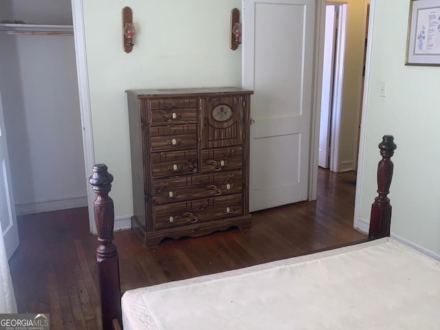 bedroom with a closet and dark hardwood / wood-style flooring