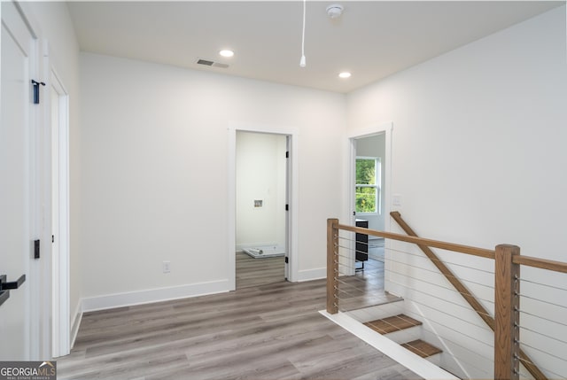 staircase with wood-type flooring