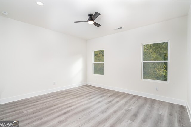 spare room featuring ceiling fan and light hardwood / wood-style floors