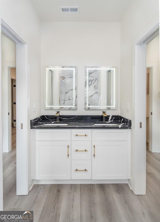 bathroom featuring hardwood / wood-style flooring and vanity