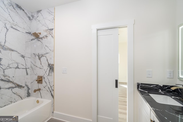 bathroom with shower / bathtub combination, hardwood / wood-style floors, and vanity