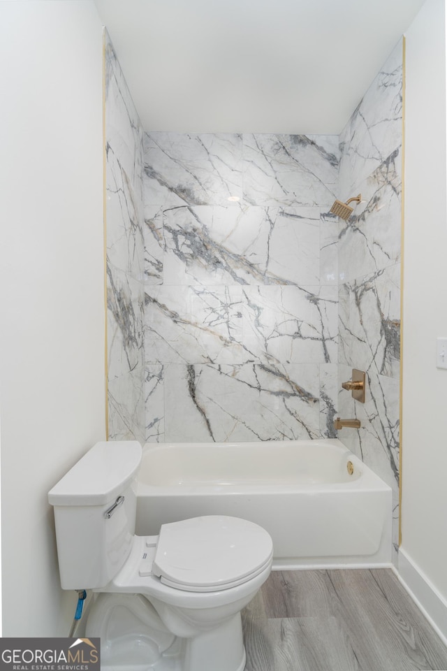 bathroom with toilet, shower / bathtub combination, and wood-type flooring