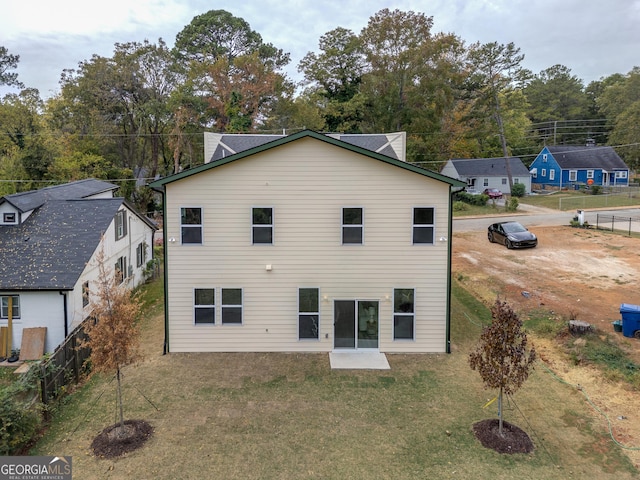 rear view of property with a yard