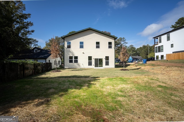 rear view of house with a yard