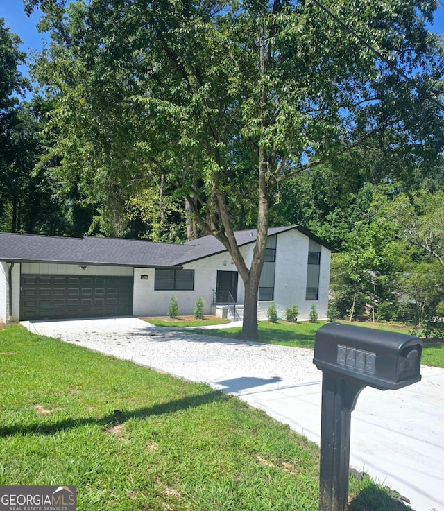 view of front facade with a front lawn and a garage