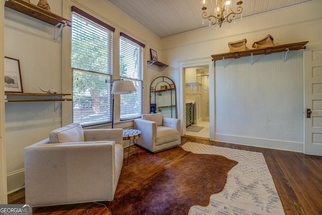 living area with a chandelier and dark hardwood / wood-style floors