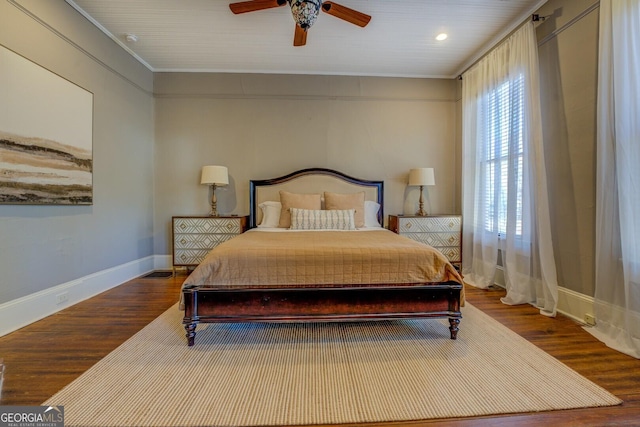 bedroom with ceiling fan, ornamental molding, and hardwood / wood-style flooring