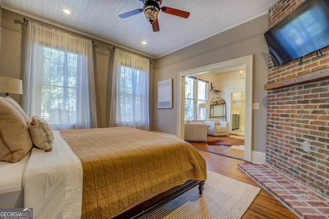 bedroom featuring multiple windows, ceiling fan, hardwood / wood-style flooring, and ornamental molding