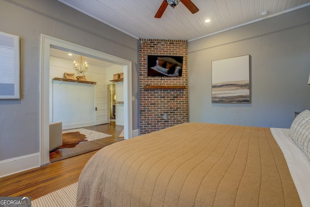 bedroom with ornamental molding, ceiling fan with notable chandelier, wood-type flooring, radiator, and wood ceiling