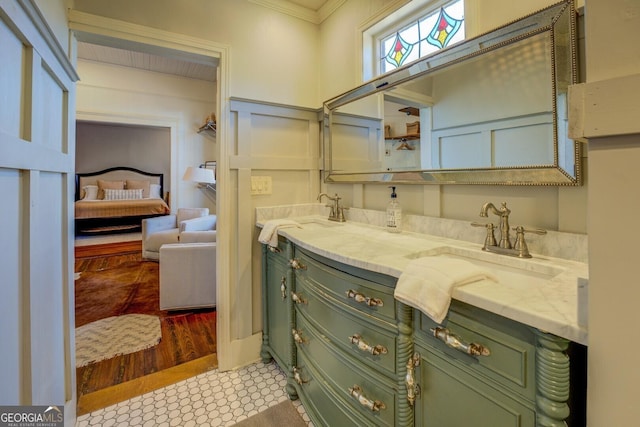 bathroom with crown molding and vanity