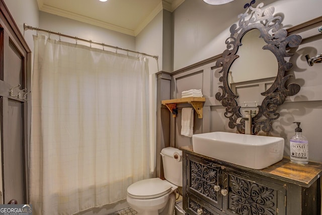 bathroom featuring toilet, ornamental molding, and sink