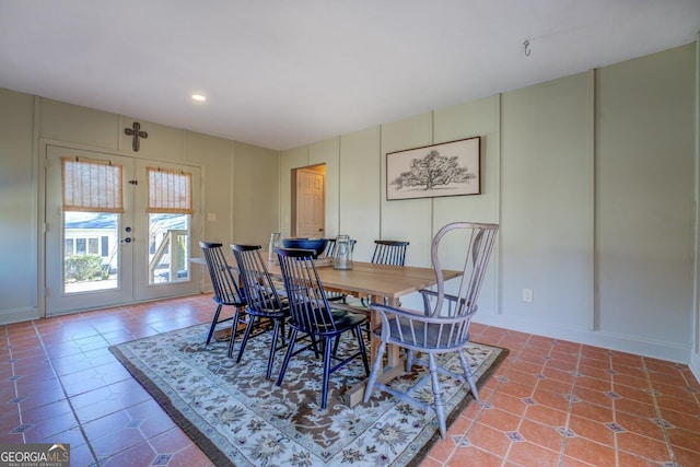 tiled dining area featuring french doors