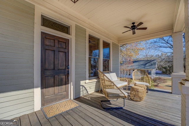 wooden terrace with ceiling fan and covered porch