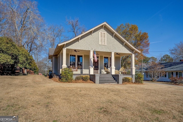 view of front of house featuring a front yard, covered porch, and ceiling fan