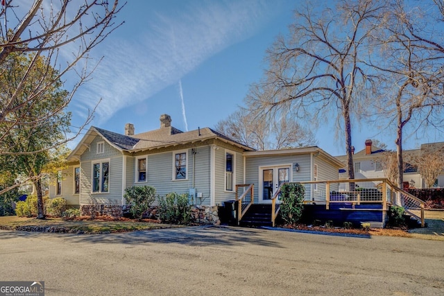 view of front of property featuring french doors and a wooden deck