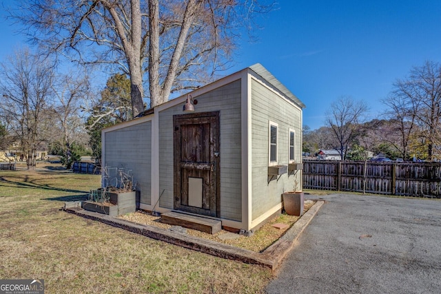 view of outbuilding featuring a lawn