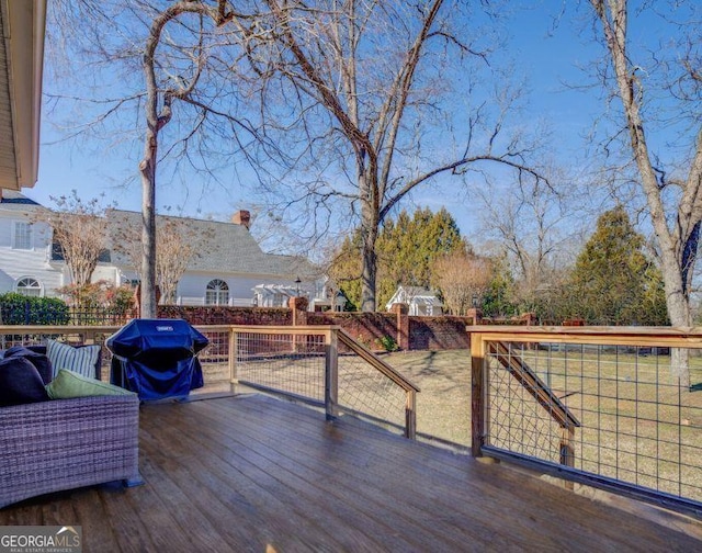 wooden deck with a grill