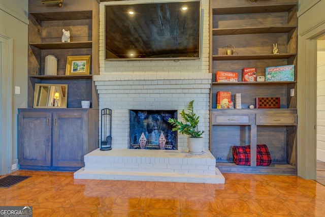 living room featuring a fireplace and built in features