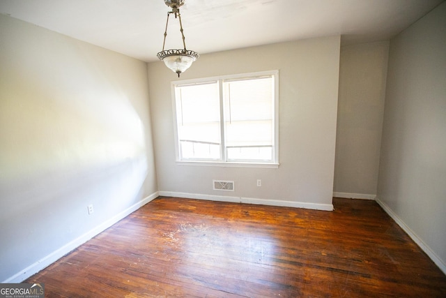 spare room featuring dark hardwood / wood-style flooring