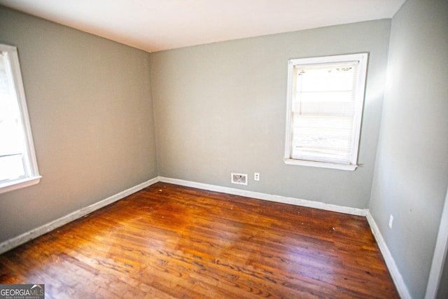 spare room featuring dark wood-type flooring