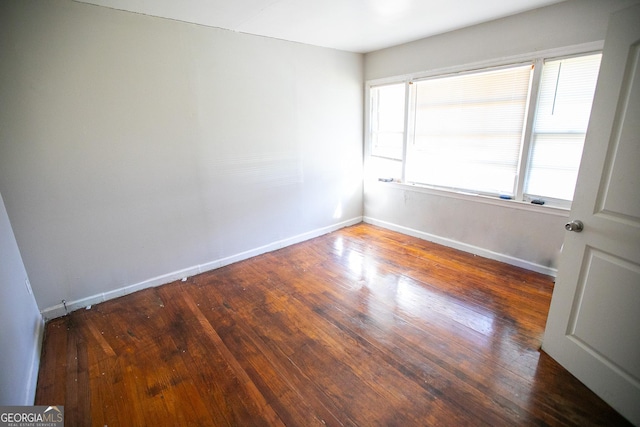 spare room with dark wood-type flooring