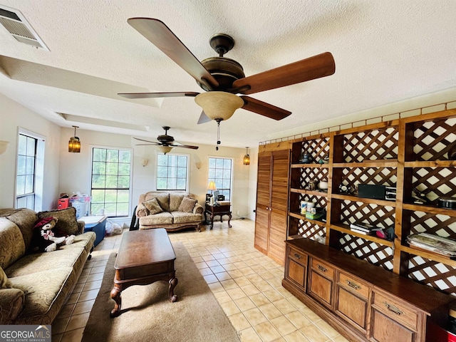 wine cellar featuring ceiling fan, light tile patterned flooring, and a textured ceiling