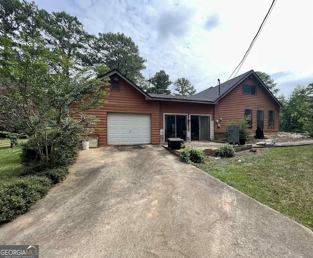 log home with a garage and a front yard