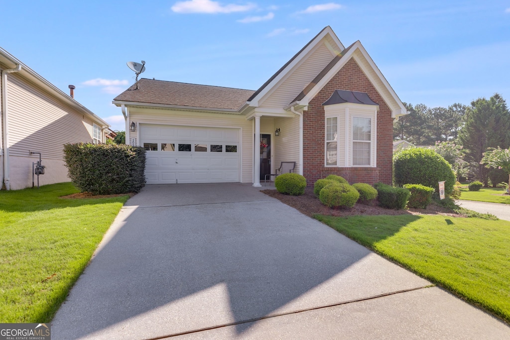 front of property with a garage and a front lawn