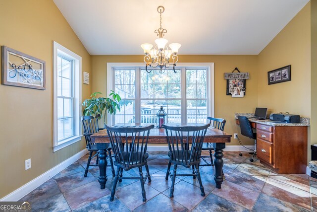 dining space with plenty of natural light, vaulted ceiling, and ceiling fan with notable chandelier