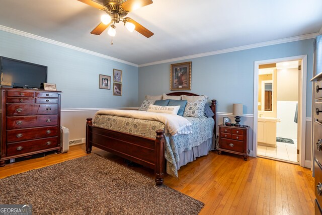 bedroom with light wood-type flooring, two closets, ceiling fan, and crown molding