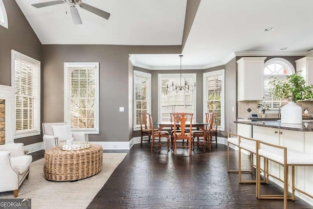 dining room featuring ornamental molding, dark hardwood / wood-style flooring, and ceiling fan with notable chandelier