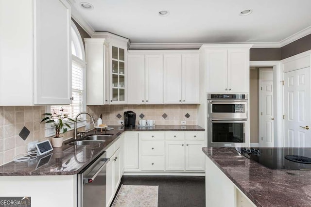 kitchen featuring sink, white cabinets, and dark stone counters