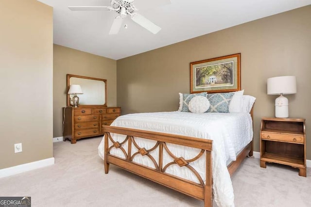 bedroom with ceiling fan and light colored carpet