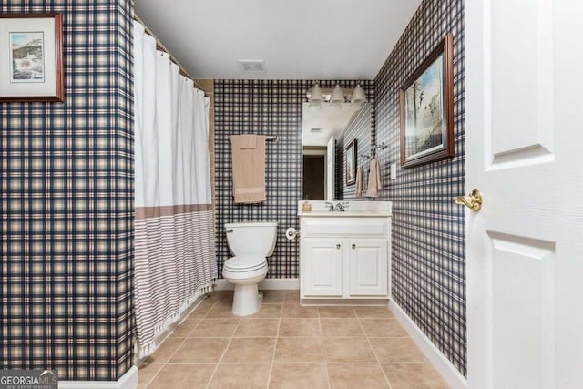 bathroom featuring vanity, tile patterned floors, and toilet