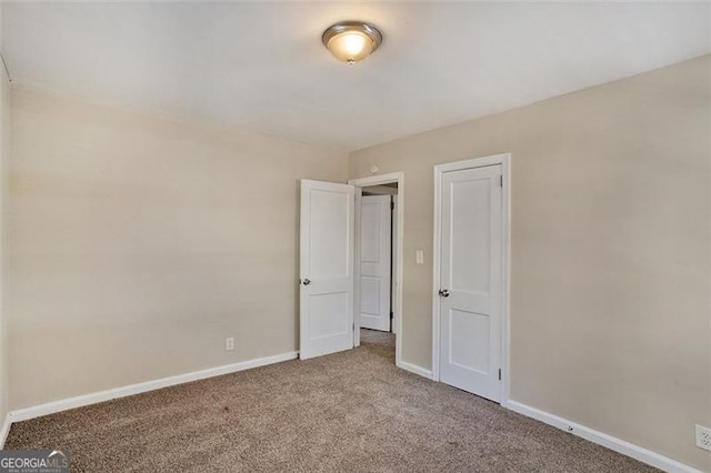 unfurnished bedroom featuring a closet and carpet